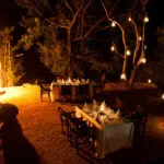 A traditional open-air boma and under the trees.