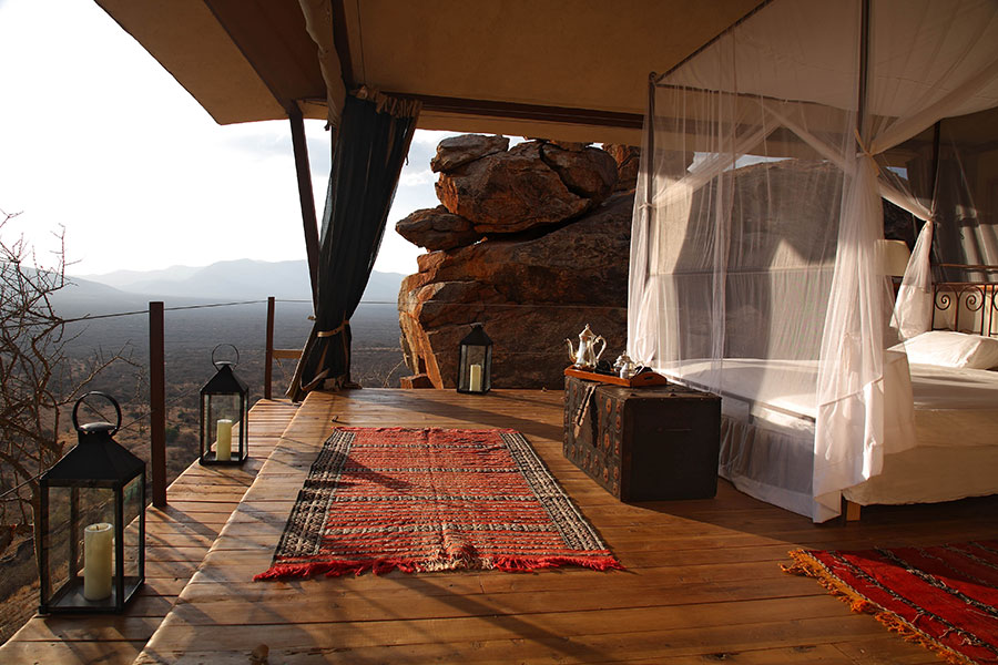 A spacious deck with a four-poster bed juts out from the rocky cliff to provide exceptional views over the surrounding valley and mountains | Go2Africa