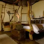 Each bedroom features eclectic style and decor, including hand-crafted wooden beds.