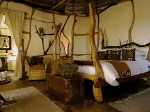 Each bedroom features eclectic style and decor, including hand-crafted wooden beds.
