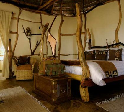 Each bedroom features eclectic style and decor, including hand-crafted wooden beds.
