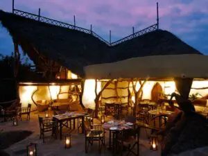 In the evening, the camp is lit up to provide a soft light over the outdoor dining area.