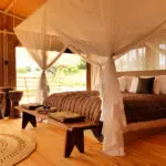 Each tent has a large four-poster bed.