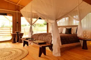 Each tent has a large four-poster bed.