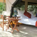 Simple & practical, each tented suite at Nkorombo opens onto a seating area with chairs & table.