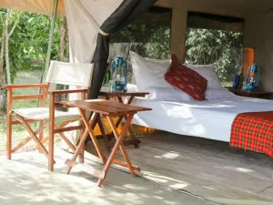 Simple & practical, each tented suite at Nkorombo opens onto a seating area with chairs & table.