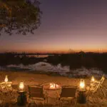Warm up by the fire after sunset at Footsteps Camp.