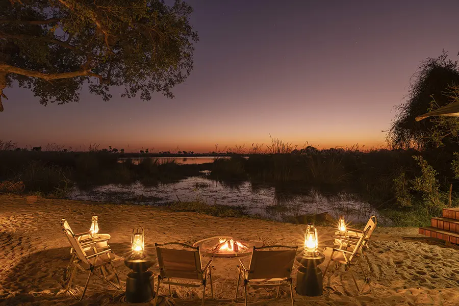 Warm up by the fire after sunset at Footsteps Camp.