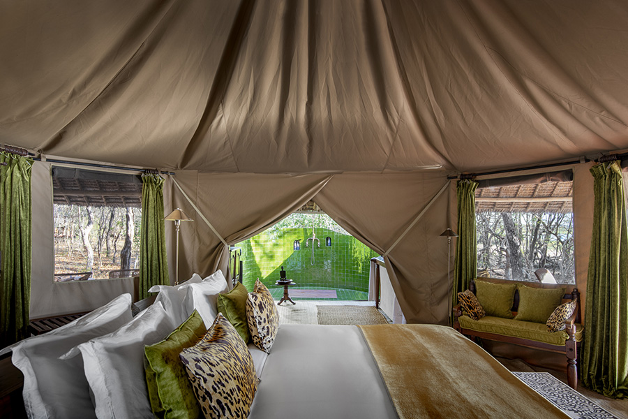 Siwandu tented suite interior with an outdoor shower.