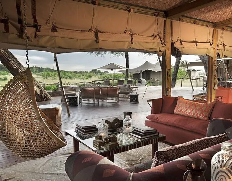 A lounge area with a glass wood-burning fireplace.