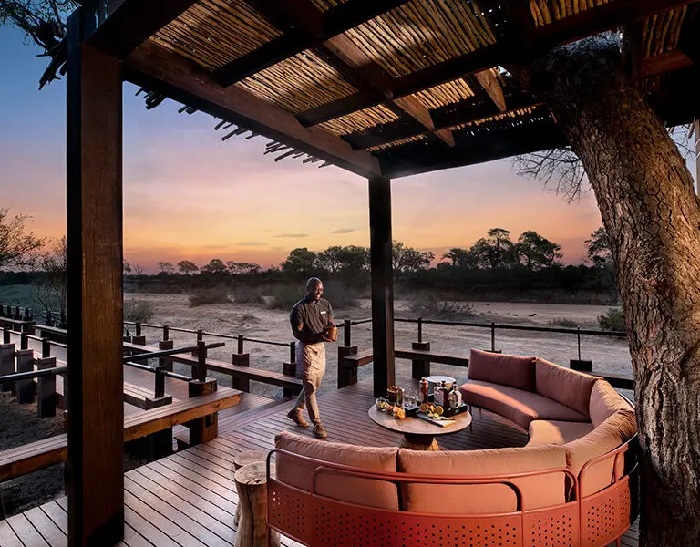 The lodge is built on raised platforms with furnished wooden viewing decks.