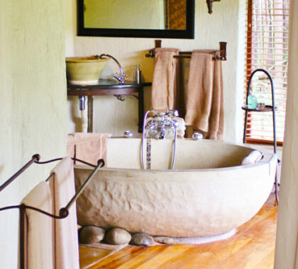 Unwind in the unique comfort of a huge stone bath, part of your luxury suite's amenities.