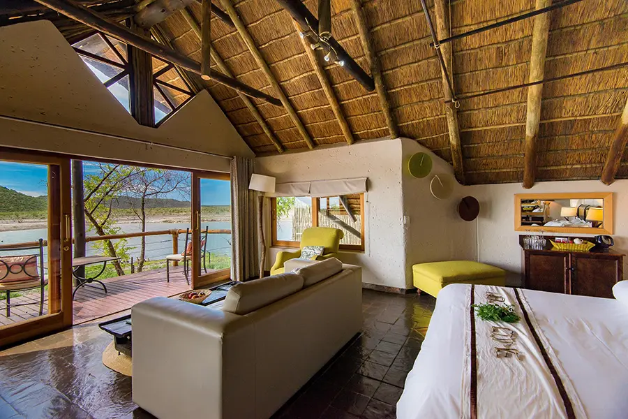 tau-game-lodge-madikwe-deluxe_chalet_view_on_waterhole