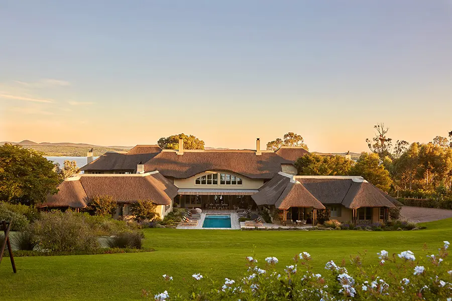 The Thatch House Boutique Hotel sits against the Cape Fold Mountains at sunset