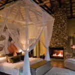 Bedroom with beautiful fireplace setting.