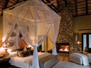 Bedroom with beautiful fireplace setting.