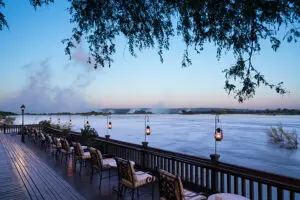 Enjoy a romantic dinner with a view of the spray of Victoria Falls.