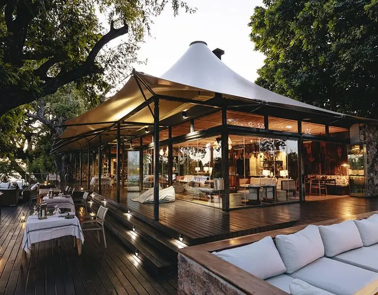 The main guest area includes plenty of lounging space - indoors and outdoors, a dining area, and a swimming pool. 