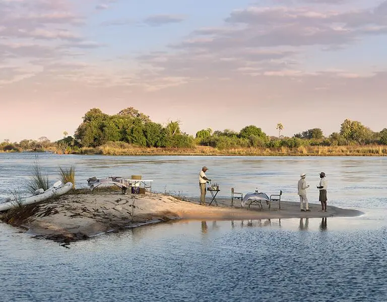 Sundowners on a small river island during a river rafting excursion.