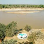 The pool is set in front of camp, close to the water's edge.