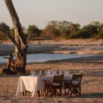 Dine on the banks of the river.