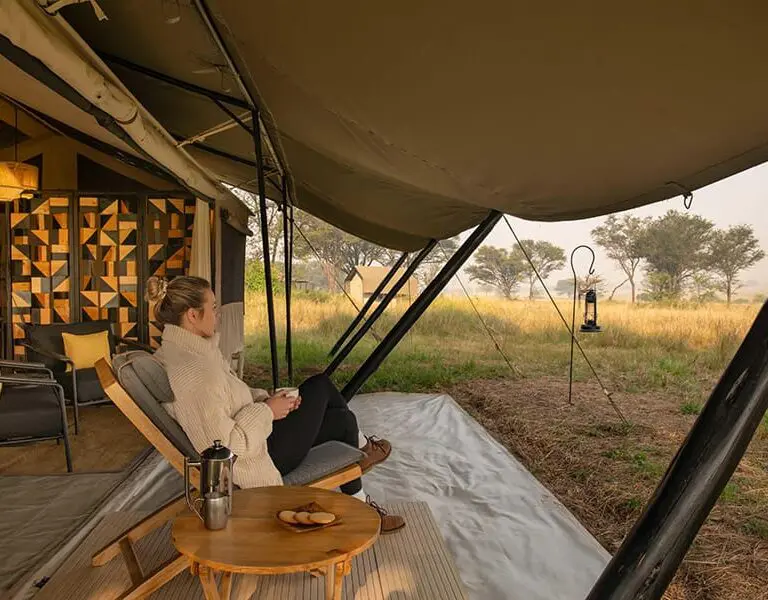 Enjoy a morning coffee on your tent veranda.