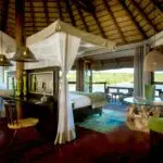 The bedroom opens up onto a private deck, providing panoramic views.
