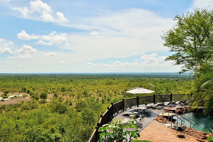 An elevated balcony appears to hover and extend over a vast view and waterhole nearby | Go2Africa