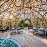 The swimming pool deck, shaded by a uniquely designed dome. 
