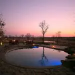 The lodge's pool at sunset with the waterhole beyond - pull up a chair & see what comes down to drink.
