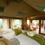 Spacious bedrooms feature wooden furnishing, comfy beds and large mesh windows.
