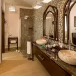 The en suite bathrooms are decorative with a Moorish-influenced mosaic shower.