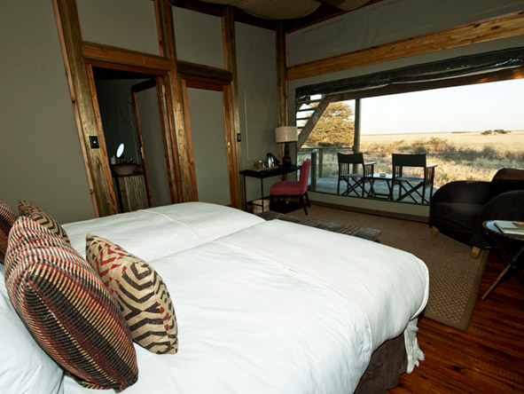 Wake up to the sight of the Kalahari's golden grasslands just steps away from your bed.