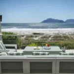 Enjoy a refreshing beverage on the wooden deck as you look out over spectacular ocean and mountain views.