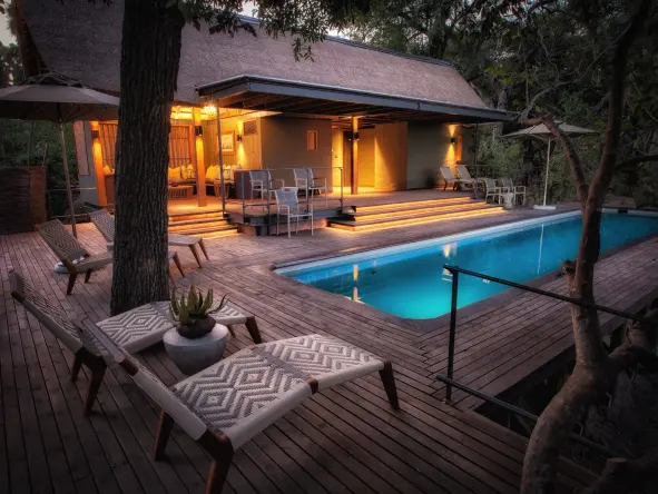 To one side of the bar a walkway leads to a delightfully cool plunge pool set about with inviting loungers.