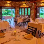 The stone and thatch restaurant has indoor and outdoor seating.
