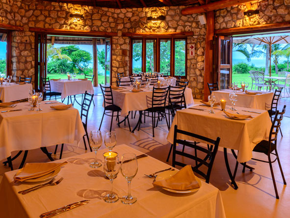 The stone and thatch restaurant has indoor and outdoor seating.
