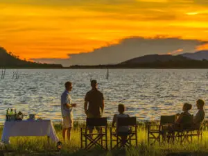 Guests gather on shore for sundowners.
