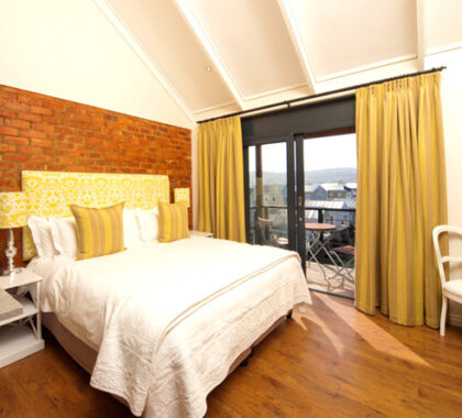 The rooms are spacious and maintain the plant's traditional look of brick walls, high ceilings, and wooden floors.