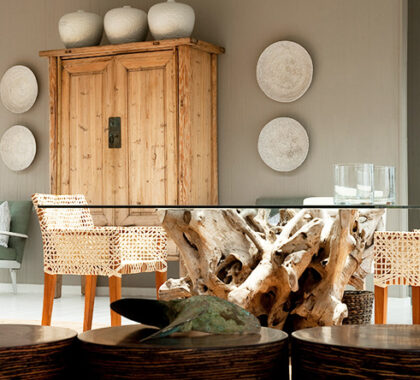 The airy interiors have a natural emphasis: repurposed driftwood, wicker, wood and glass all feature.
