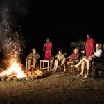 Share stories about the day's adventures around the campfire at Porini Lion Camp.