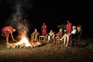 Share stories about the day's adventures around the campfire at Porini Lion Camp.