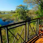 Watch hippos splash in the river from your suite's private deck.