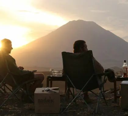 Sit back and sip on a sundowner drink of your choice while the silhouette of Oldoinyo Lengai volcano dominates the skyline.