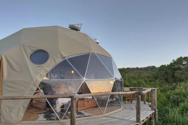 The Highlands exterior of done tent showing off the deck and views into the forest