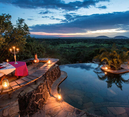 A romantic dinner set up by the pool at ololo with breath-taking views of the Nairobi National Park.