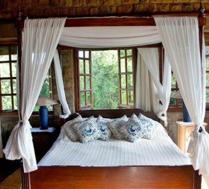 The beds are draped with mosquito nets and have large windows that overlook the lush garden.