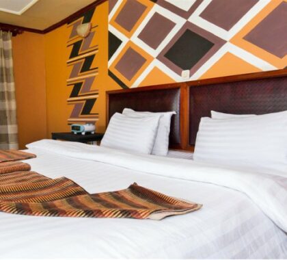 The bedrooms are dressed with traditional patterns and comfortable linens.