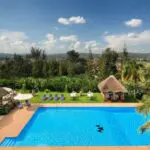 Sink into a comfortable sun lounger beside the pool with a refreshing cocktail in hand.