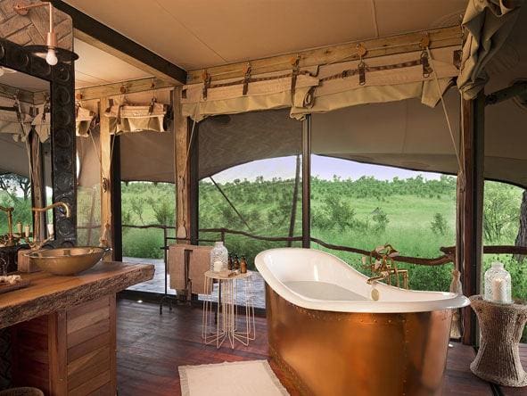 Each tent at Somalisa has en suite bathroom facilities including an indoor and outdoor shower, as well as a copper slipper-style bathtub.